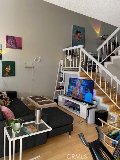 living room with a textured ceiling and hardwood / wood-style flooring