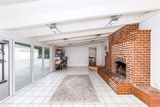 unfurnished living room with vaulted ceiling with beams, light tile patterned floors, and a brick fireplace