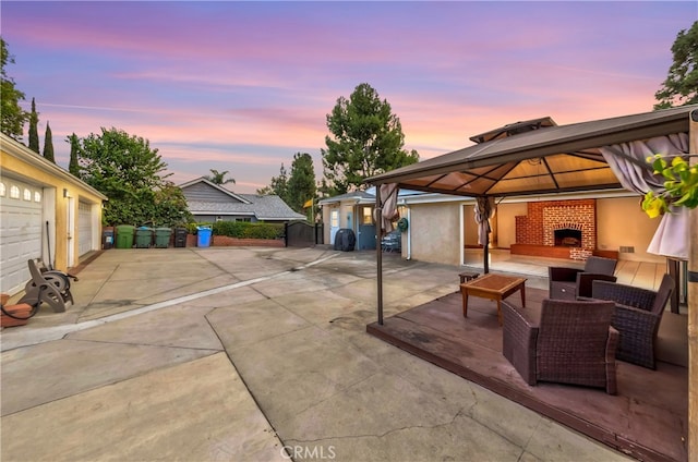 patio terrace at dusk with a gazebo and an outdoor living space