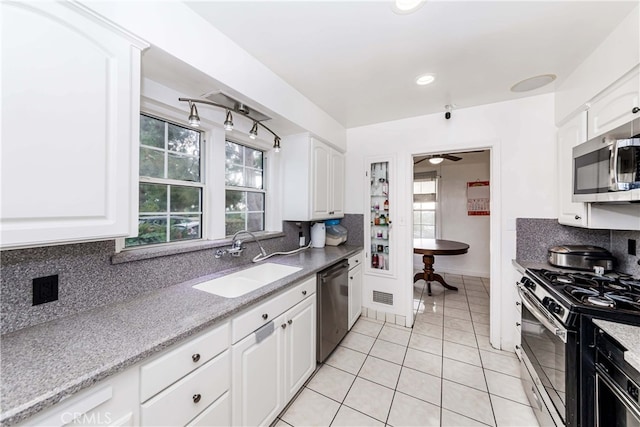 kitchen featuring sink, white cabinets, stainless steel appliances, and plenty of natural light