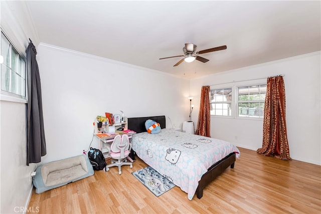 bedroom with ceiling fan, ornamental molding, and hardwood / wood-style flooring