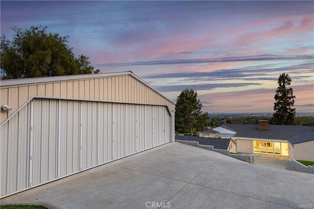 view of garage at dusk