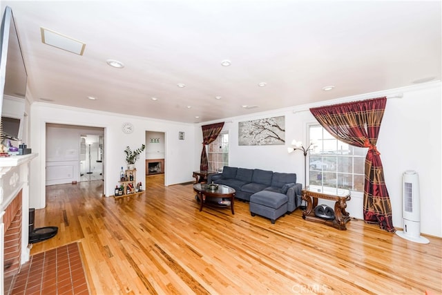 living room with hardwood / wood-style floors and ornamental molding