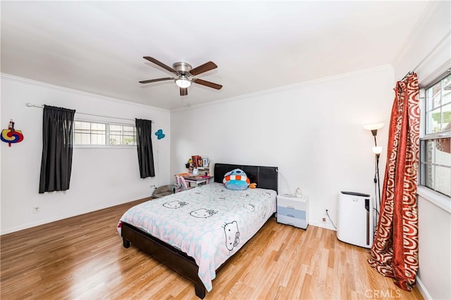 bedroom with ceiling fan, light hardwood / wood-style floors, and ornamental molding