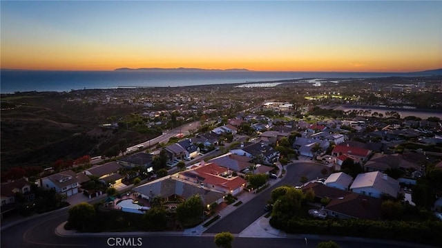 aerial view at dusk with a water view