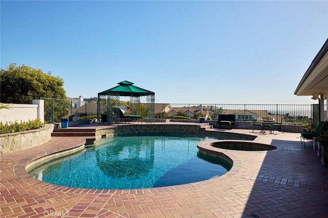 view of pool featuring a gazebo, an in ground hot tub, and a patio