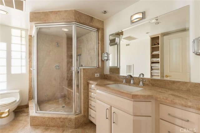 bathroom with plenty of natural light, vanity, an enclosed shower, and toilet