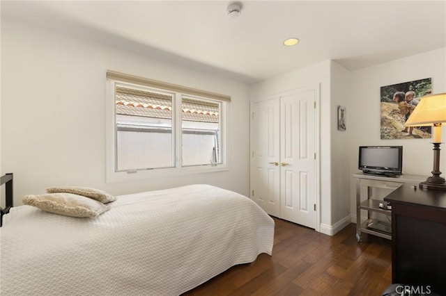 bedroom featuring a closet and dark hardwood / wood-style flooring