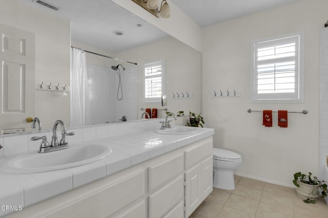 full bathroom with toilet, a sink, visible vents, and tile patterned floors