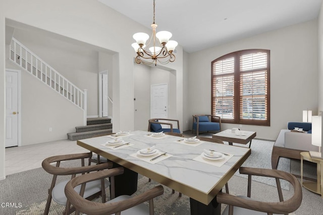 dining room featuring stairs, light tile patterned floors, and a notable chandelier