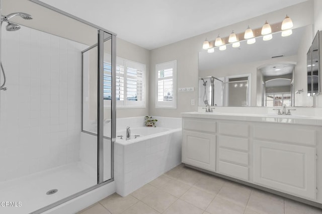 full bath with tile patterned flooring, a sink, a bath, double vanity, and a stall shower