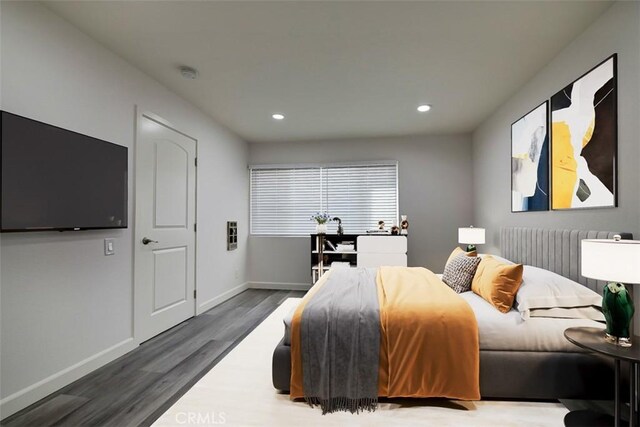 bedroom with dark hardwood / wood-style flooring and radiator