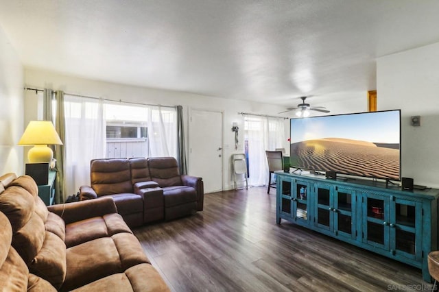 living room with ceiling fan and dark wood-type flooring