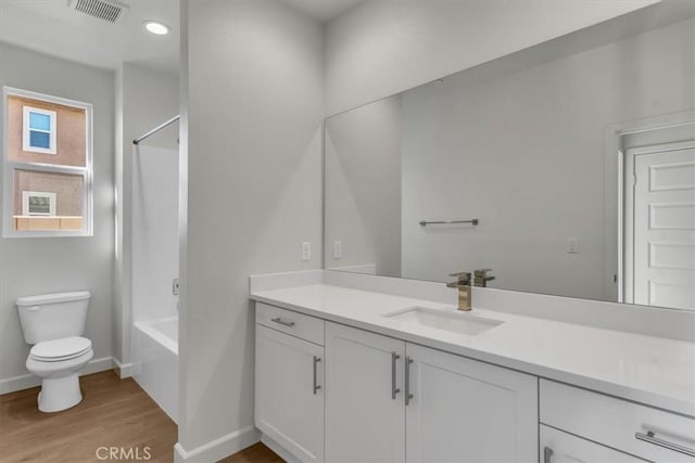 full bathroom with vanity, toilet, shower / bath combination, and wood-type flooring