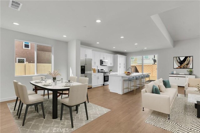 dining area featuring light hardwood / wood-style flooring and sink