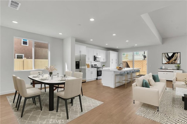 dining space featuring sink and light hardwood / wood-style floors