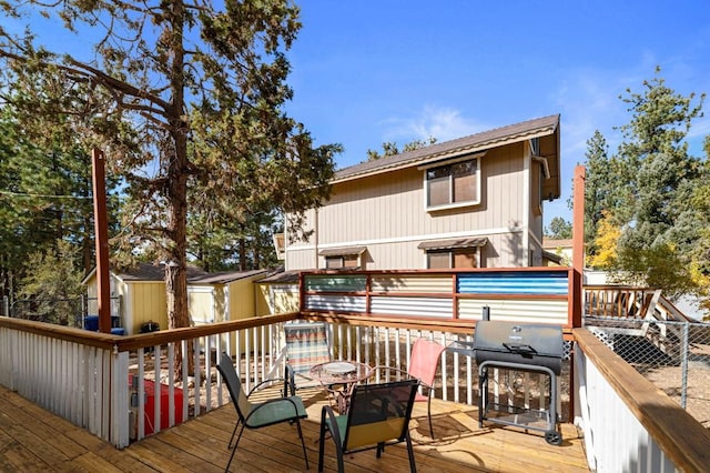 deck featuring grilling area and a shed