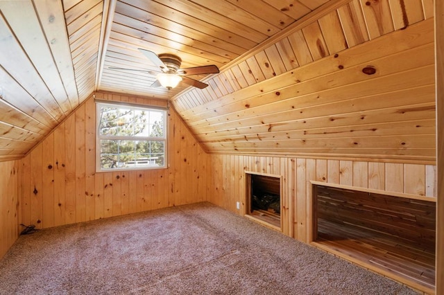 bonus room featuring carpet flooring, wood walls, wooden ceiling, and lofted ceiling