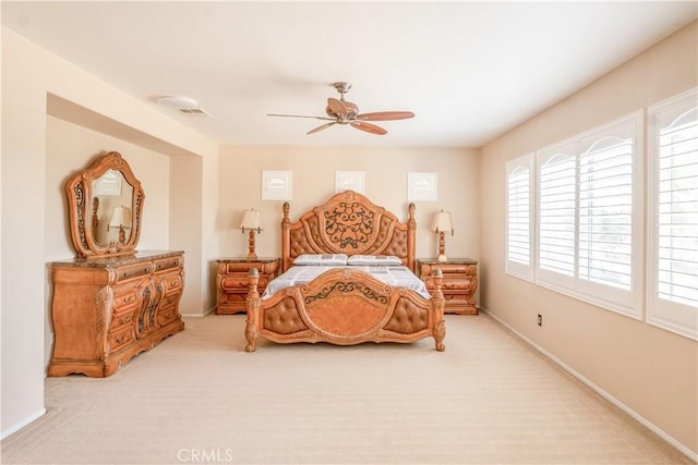 bedroom featuring light carpet and ceiling fan