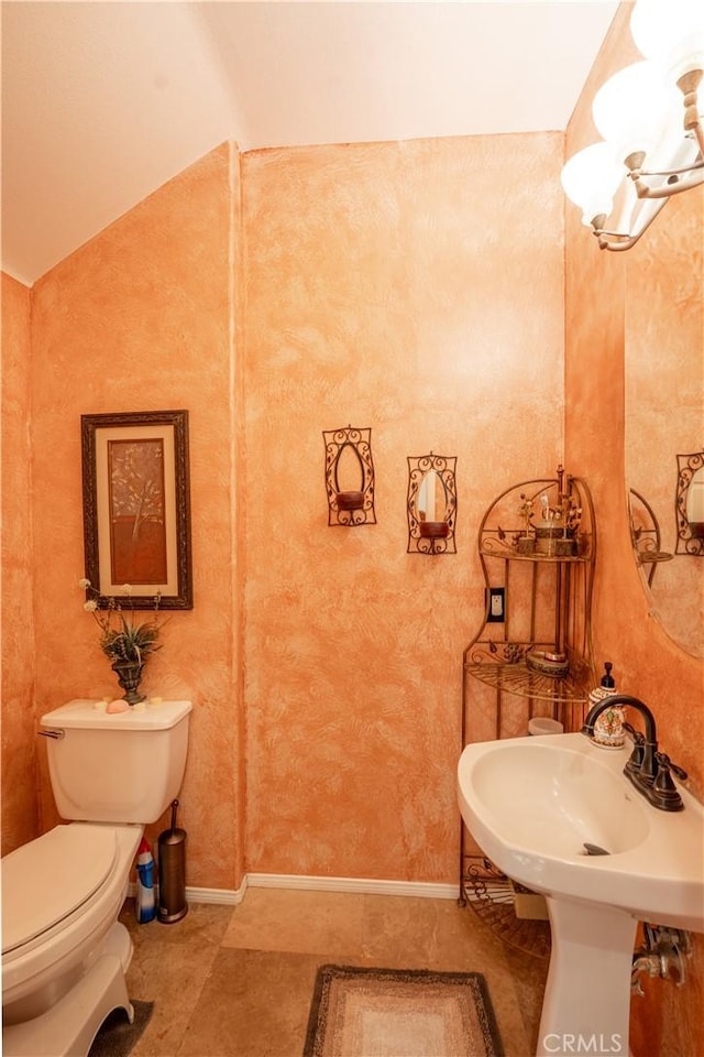 bathroom featuring tile patterned floors, toilet, lofted ceiling, and sink