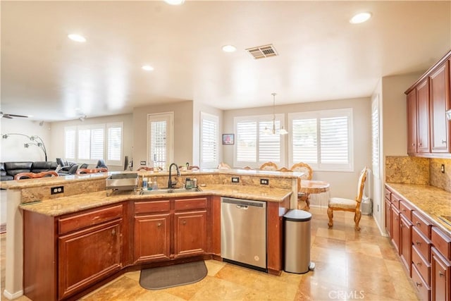 kitchen with ceiling fan, sink, light stone counters, stainless steel dishwasher, and decorative light fixtures