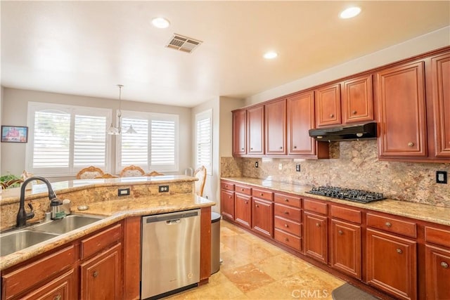 kitchen featuring gas stovetop, sink, pendant lighting, dishwasher, and a chandelier