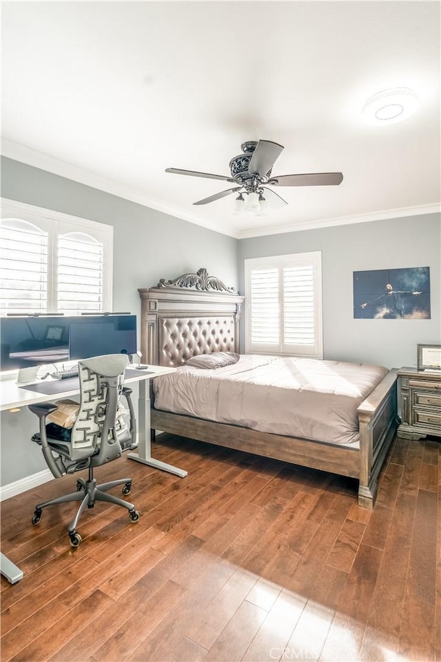 bedroom with ceiling fan, wood-type flooring, crown molding, and multiple windows