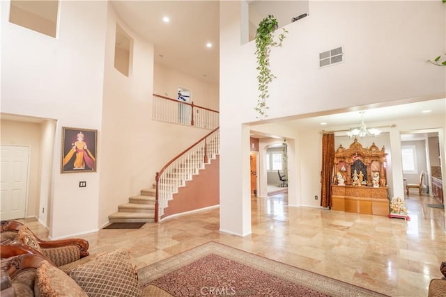 living room featuring a towering ceiling and an inviting chandelier