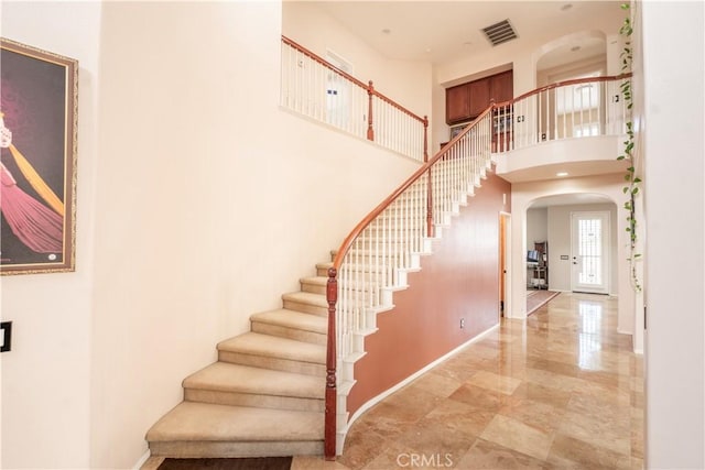 stairway with a towering ceiling