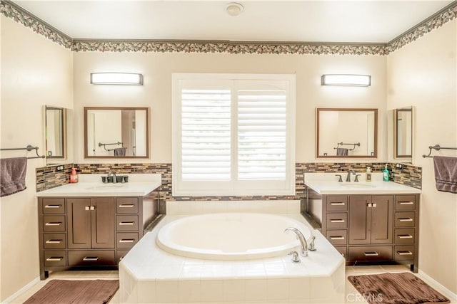 bathroom with vanity and tiled bath