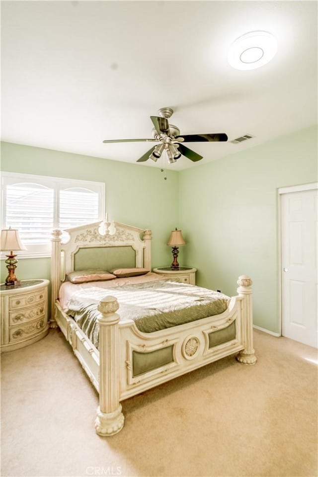 bedroom with light colored carpet and ceiling fan