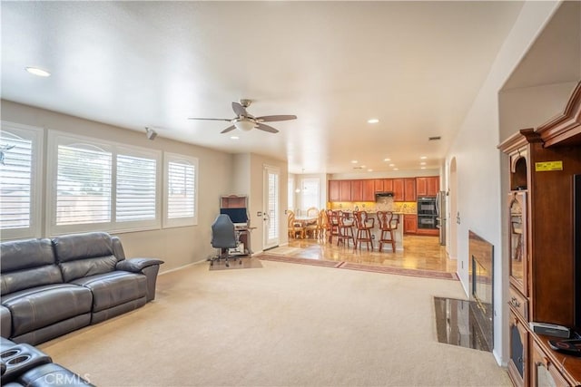 living room with light carpet and ceiling fan