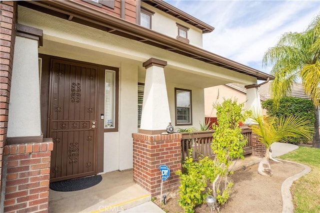 entrance to property featuring a porch