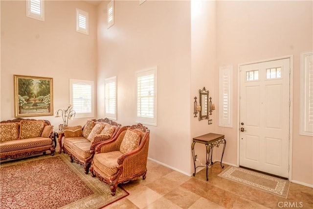 foyer featuring a towering ceiling and plenty of natural light