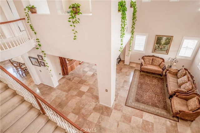 staircase featuring a towering ceiling