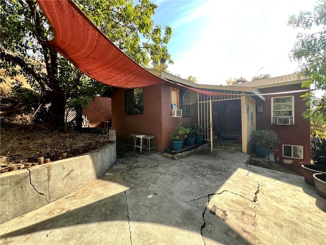 view of property exterior featuring cooling unit and a patio area