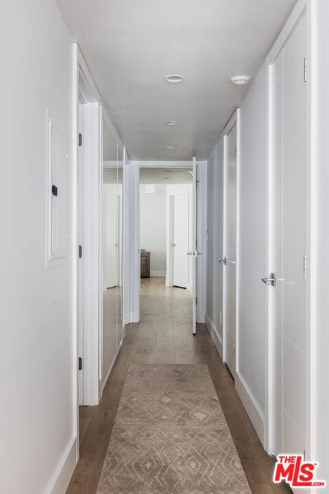 hall with electric panel and light hardwood / wood-style floors