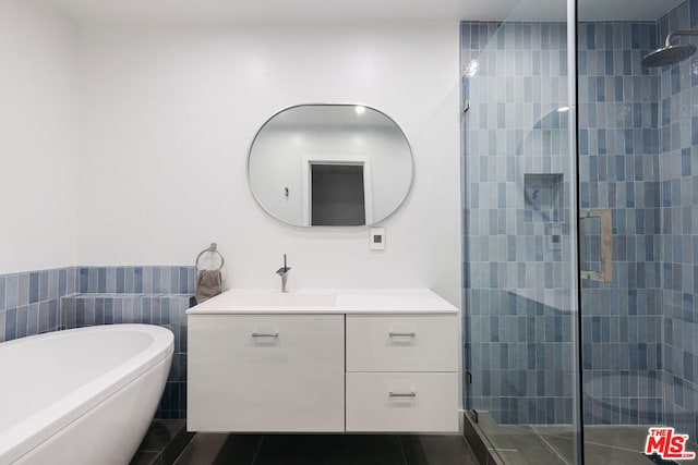 bathroom featuring vanity, shower with separate bathtub, and tile patterned floors