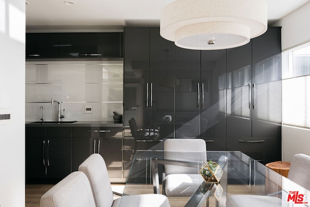 dining room with sink and dark wood-type flooring