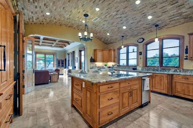 kitchen with decorative light fixtures, a center island, plenty of natural light, and sink