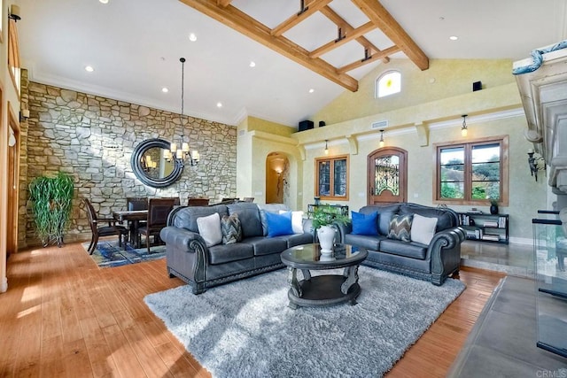 living room with high vaulted ceiling, crown molding, beam ceiling, wood-type flooring, and a chandelier