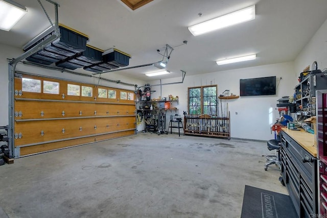 garage with a workshop area and a garage door opener