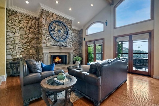 living room with crown molding, light hardwood / wood-style flooring, high vaulted ceiling, and french doors