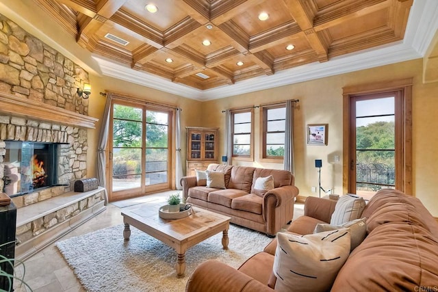 living room with beam ceiling, a stone fireplace, crown molding, and coffered ceiling