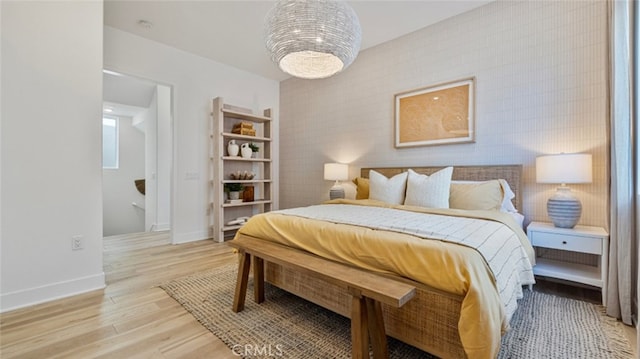 bedroom with light wood-type flooring and tile walls