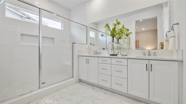 bathroom with vanity and a shower with door