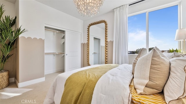 bedroom with an inviting chandelier, light colored carpet, a closet, and multiple windows