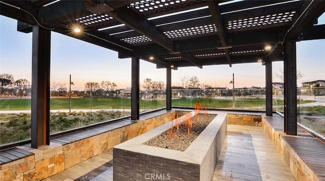 surrounding community featuring a pergola and a fire pit