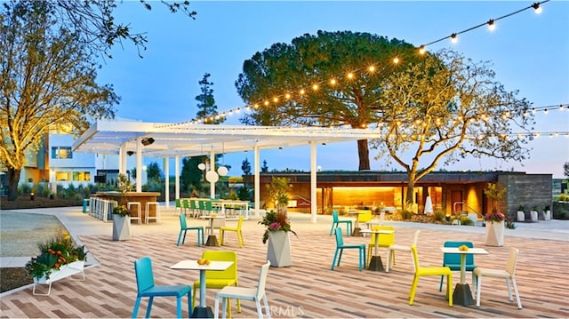 view of property's community featuring a pergola and an outdoor bar