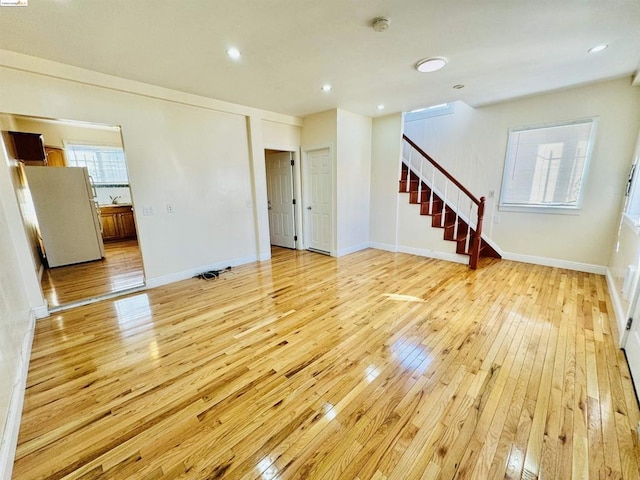 unfurnished living room featuring light hardwood / wood-style floors